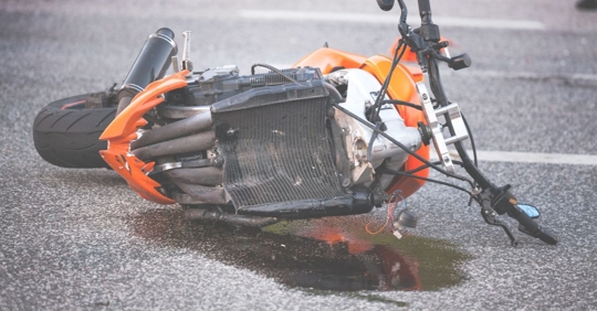 a fallen and broken motorcycle