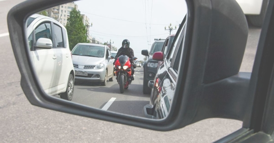 oncoming motorcyclist in sideview mirror