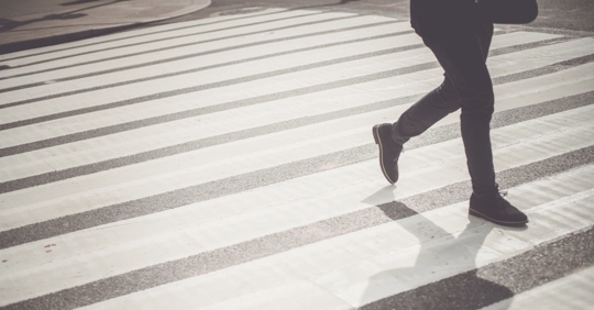 person walking across crosswalk
