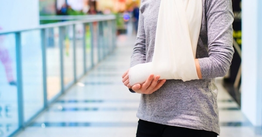 image of a young person in an arm cast and sling