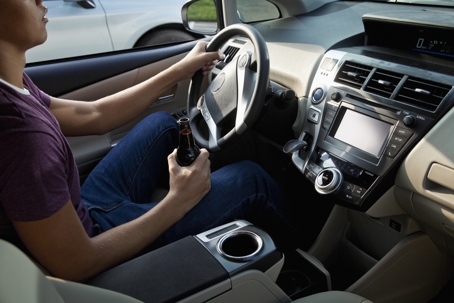 Young man drinking and driving