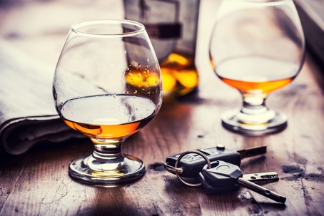 Two cups of cognac brandy or rum with car keys.