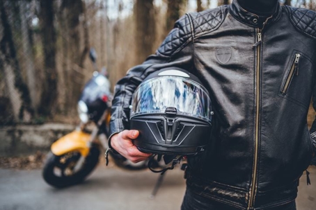 Man holding motorcycle helmet